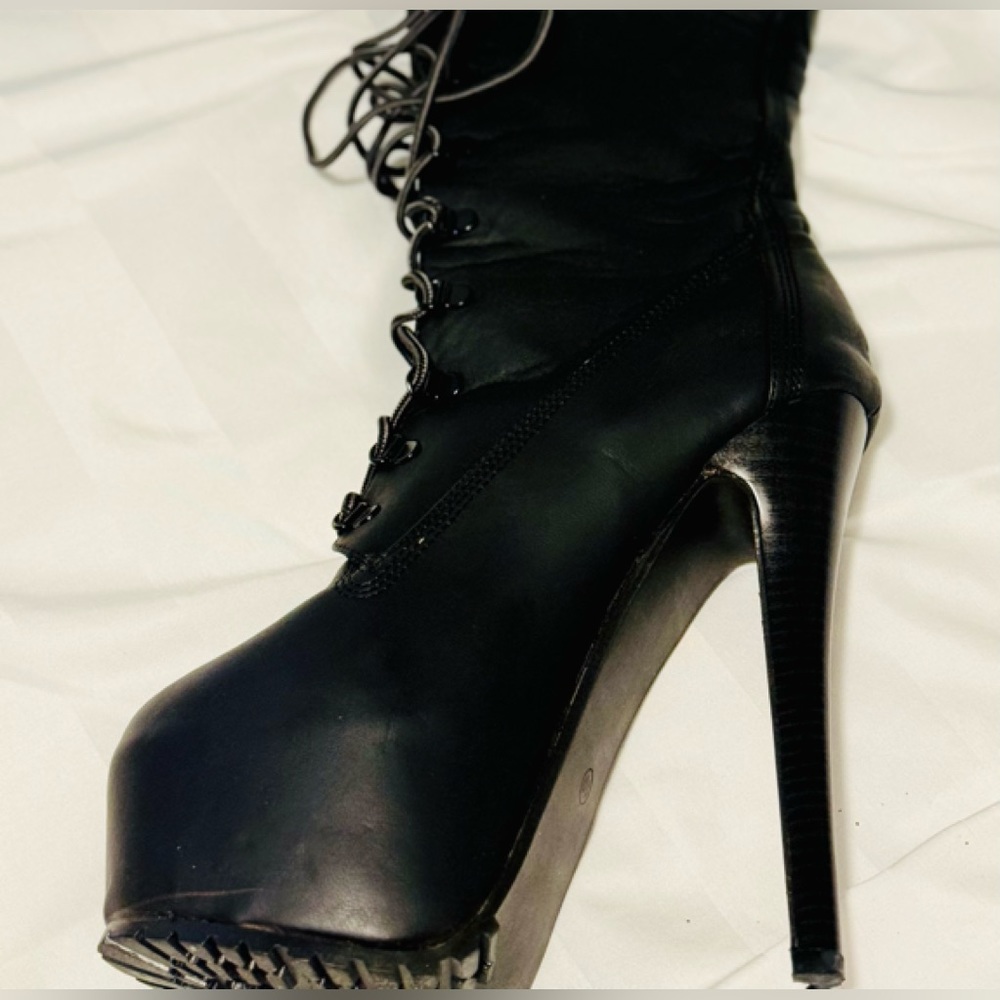 Women’s lace up thigh high platform boots.